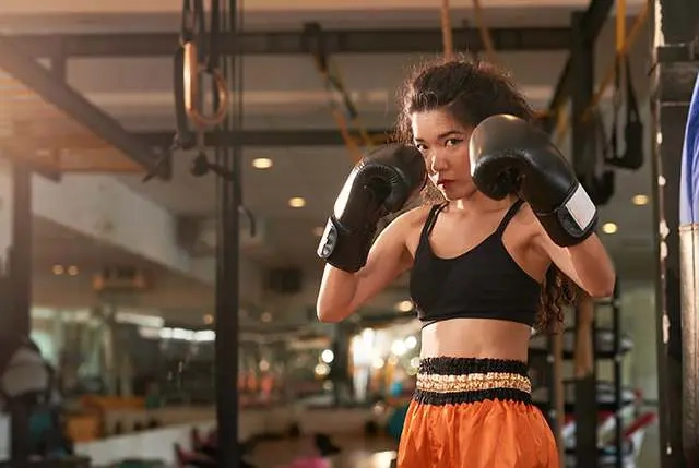 First Muay Thai class tips for beginners practicing Muay Thai stance and footwork inside a training gym